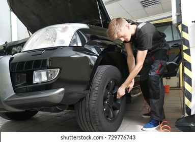 Young Mechanic Working In Body Shop