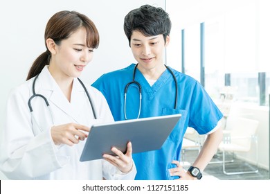 Young Medical Doctors Talking In The Hospital.