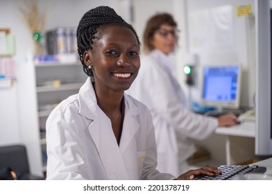 Young medical officer smilling next to her work space - Shutterstock ID 2201378719