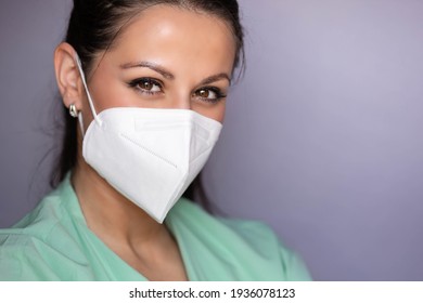 Young Medical Professional, Nurse With Protective Mask And Smiling Eyes. Isolated On Gray Background