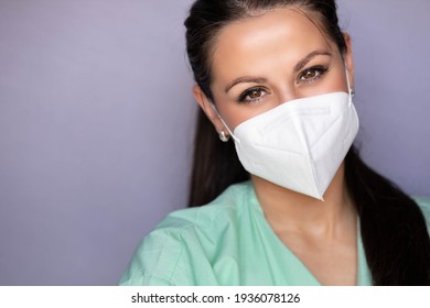 Young Medical Professional, Nurse With Protective Mask And Smiling Eyes. Isolated On Gray Background