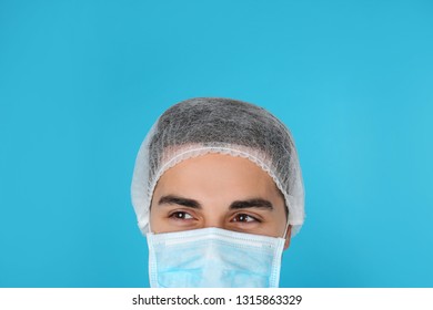 Young Medical Student With Face Mask And Surgical Cap On Color Background, Closeup