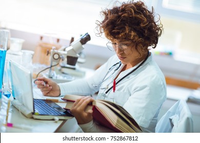 Young Medical Student Learning And Writes In Laboratory