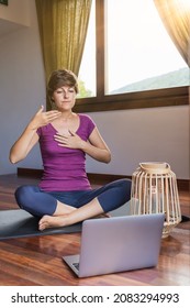 Young Meditation Teacher Teaching Pranayama Breathing From Her Computer At Home.