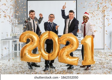 Young men celebrating New Year at corporate party in office - Shutterstock ID 1862552050