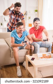 Young Men Drink Beer, Eat Pizza And Play Games Play Station