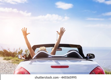 Young Men Drive A Car On The Beach.