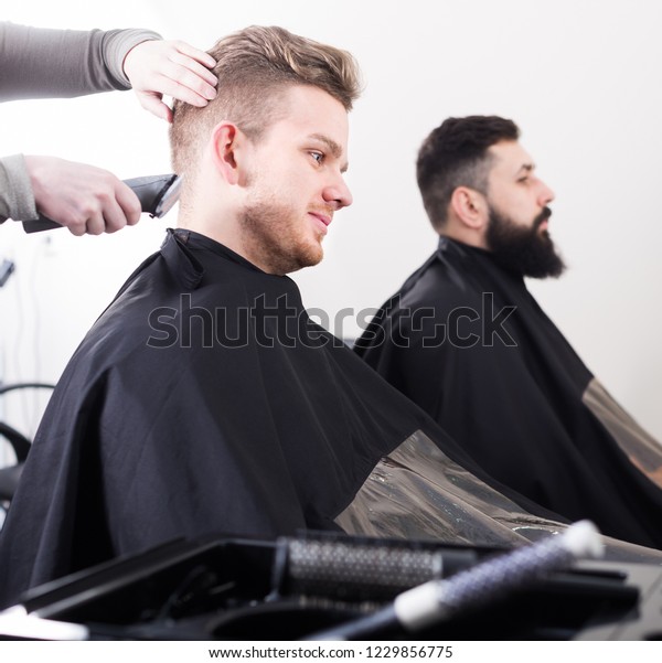 Young Men Having Their Hair Cut Stock Photo Edit Now 1229856775