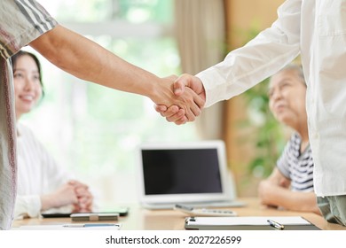 Young Men And Older Men Shaking Hands