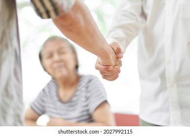 Young Men And Older Men Shaking Hands