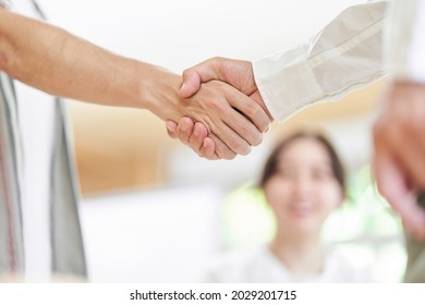 Young Men And Older Men Shaking Hands