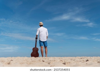 Young men playing acoustic guitar on the beach. Happy man person playing acoustic guitar music instrument seaside sitting on sand tropical beach island. Asian musician Happy guitarist hobby lifestyle - Powered by Shutterstock