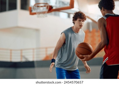 Young men playing basketball during sports practice at indoor court. Copy space.  - Powered by Shutterstock