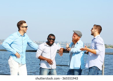 Young men relaxing on the riverside