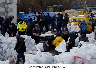 Young Men And Women Carry Sandbags. They Are Building A Shelter Against The Russian Army. Odessa, Ukraine, March 2, 2022.