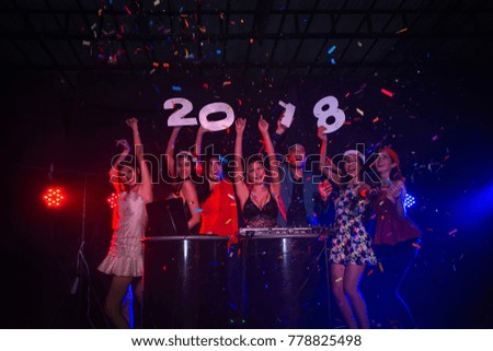 Young men and women are celebrating new year 2018 happily in the party.