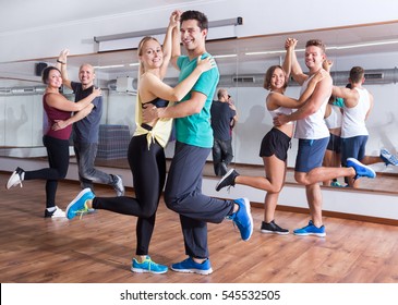 Young Men And Women Dancing The Salsa O Bachata In Dance Hall 