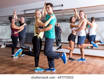 Young Men And Women Dancing Swing In Dance Hall