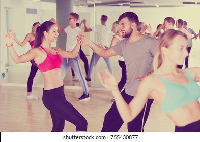 Young Men And Women Dancing Swing In Dance Class