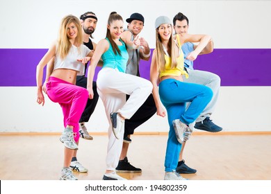 Young Men And Women Dancing Zumba Modern Group Choreography In Dance School