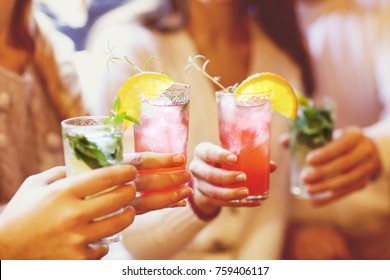 Young men and women drinking cocktail at party - Shutterstock ID 759406117
