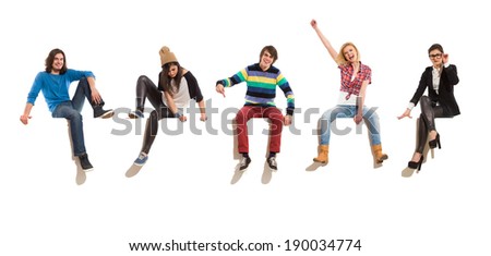 Young men and women sitting on a banner, smiling and gesturing. Full length studio shot isolated on white.