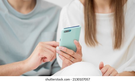 Young Men And Women Using Smart Phones