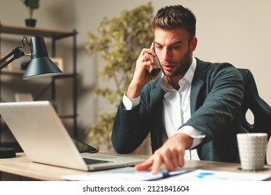 Young men work from home overtime - Shutterstock ID 2121841604