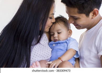 Young Mexican Family Expressing Love