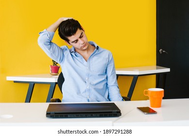 Young Mexican Man Meditating And Doing Yoga In Office In Latin America