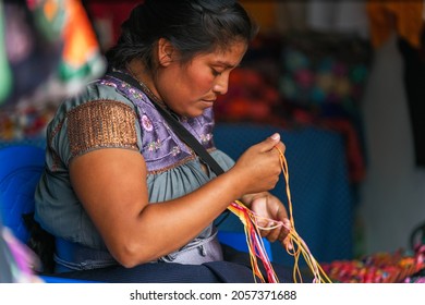 Young Mexican Woman Embroidering Typical Regional Blouses And Shirts