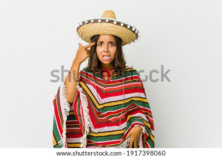 Young mexican woman isolated on white background showing a disappointment gesture with forefinger.