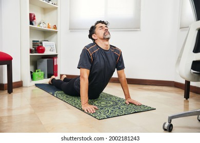 Young Middle Aged Man Doing Yoga And Fitness At Home