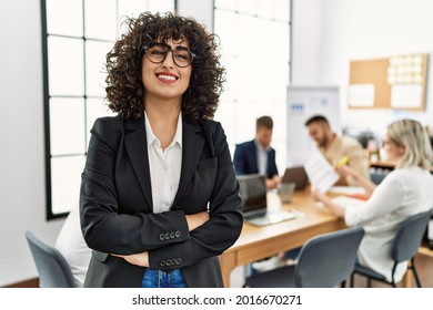 Young Middle East Businesswoman Smiling Happy Standing With Arms Crossed Gesture At The Office During Business Meeting.