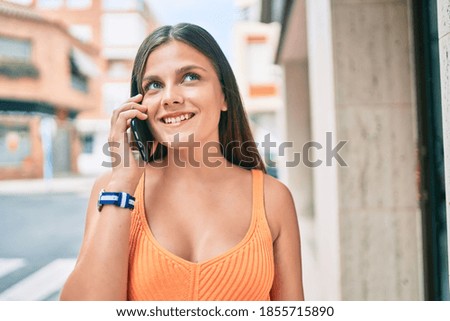 Young middle east girl smiling happy talking on the smartphone at the city.