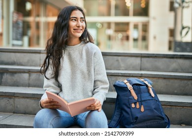 Young Middle East Student Girl Smiling Happy Reading Book At The University.