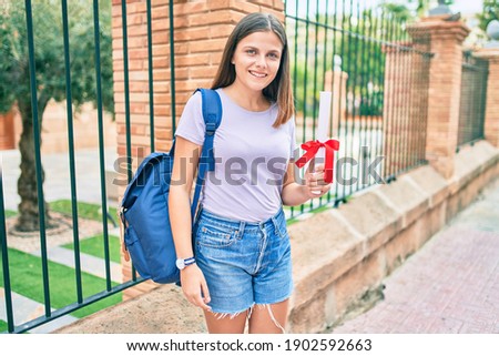 Young middle east student girl smiling happy holding diploma at the university campus.