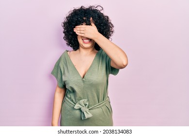 Young Middle East Woman Wearing Casual Clothes Smiling And Laughing With Hand On Face Covering Eyes For Surprise. Blind Concept. 