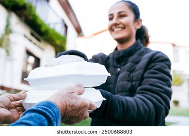 Young middle eastern female volunteer delivering meals. Grocery delivery service - Powered by Shutterstock