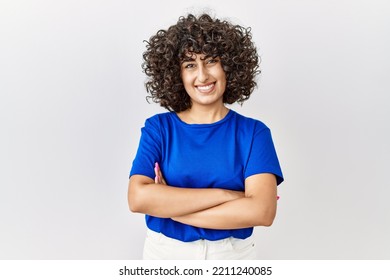 Young middle eastern woman standing over isolated background happy face smiling with crossed arms looking at the camera. positive person.  - Powered by Shutterstock