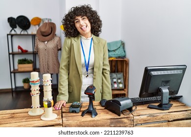 Young Middle Eastern Woman Working As Manager At Retail Boutique Sticking Tongue Out Happy With Funny Expression. Emotion Concept. 