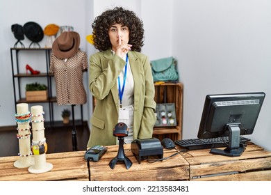 Young Middle Eastern Woman Working As Manager At Retail Boutique Asking To Be Quiet With Finger On Lips. Silence And Secret Concept. 