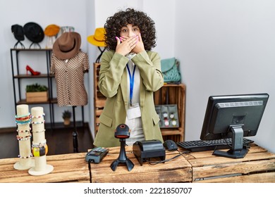 Young Middle Eastern Woman Working As Manager At Retail Boutique Shocked Covering Mouth With Hands For Mistake. Secret Concept. 