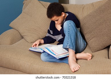 Young Middle School Student Studying Intensely In His Notebook.