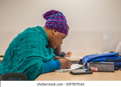 Young Migrant Woman From Africa In National Clothes Is Trained In German At A Language School In Halle (Saale), Germany, May 24, 2018