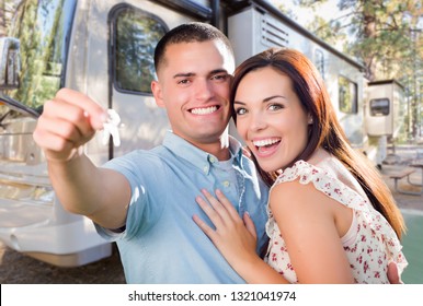 Young Military Couple Holding In Front Of New RV.