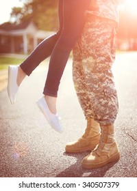 Young Military Couple Kissing Each Other, Homecoming Concept, Warm Orange Toning Applied