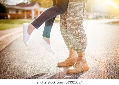 Young Military Couple Kissing Each Other, Homecoming Concept, Warm Orange Toning Applied