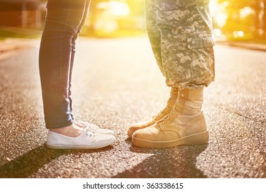 Young Military Couple Kissing Each Other, Homecoming Concept, Soft Focus,warm Orange Toning Applied