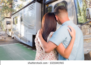 Young Military Couple Looking At New RV.